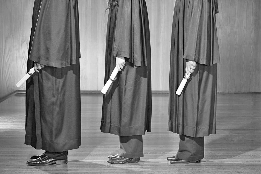 A line of students and their robes at a graduation ceremony.
