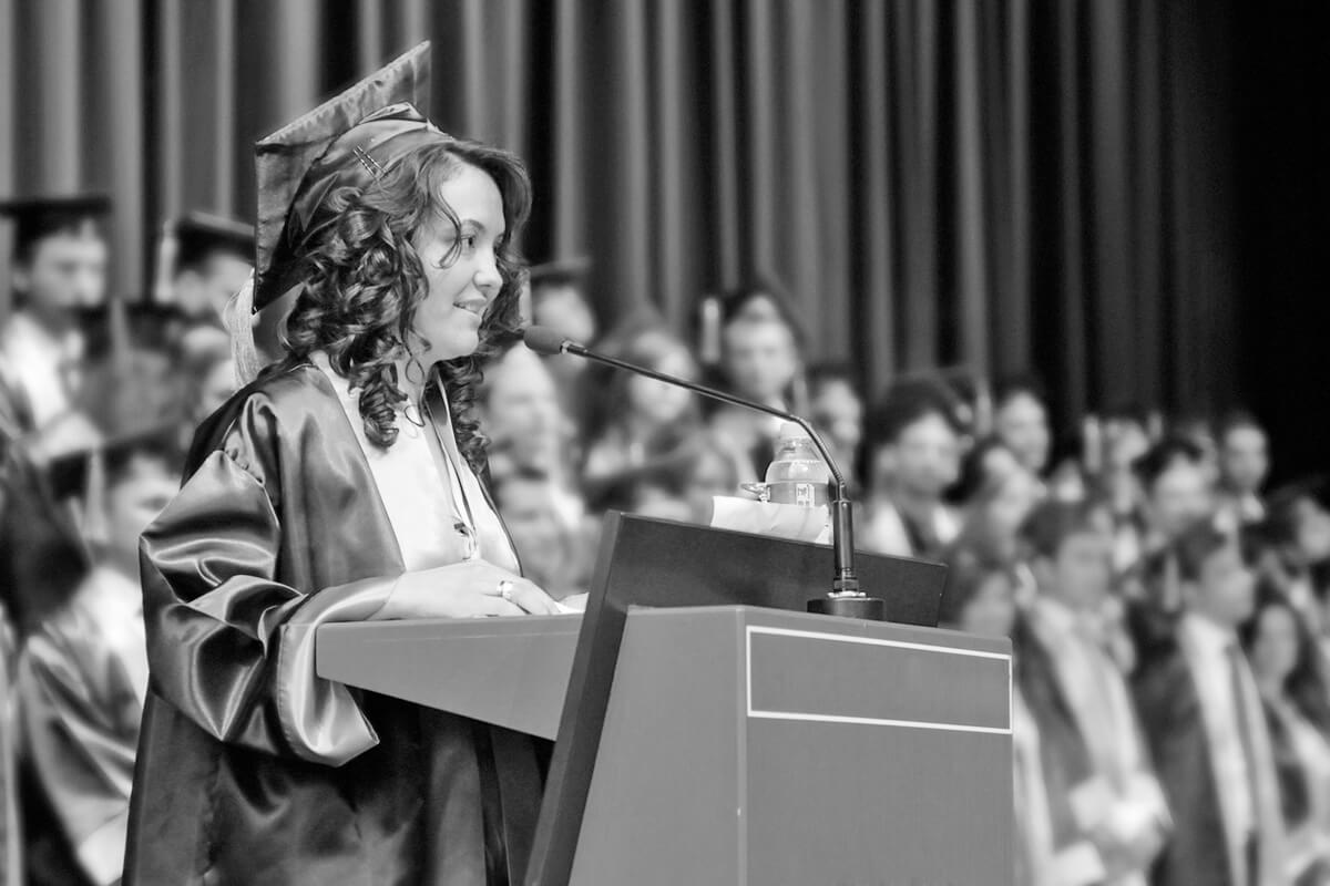 A successful student of university is making a speech in her graduation ceremony.