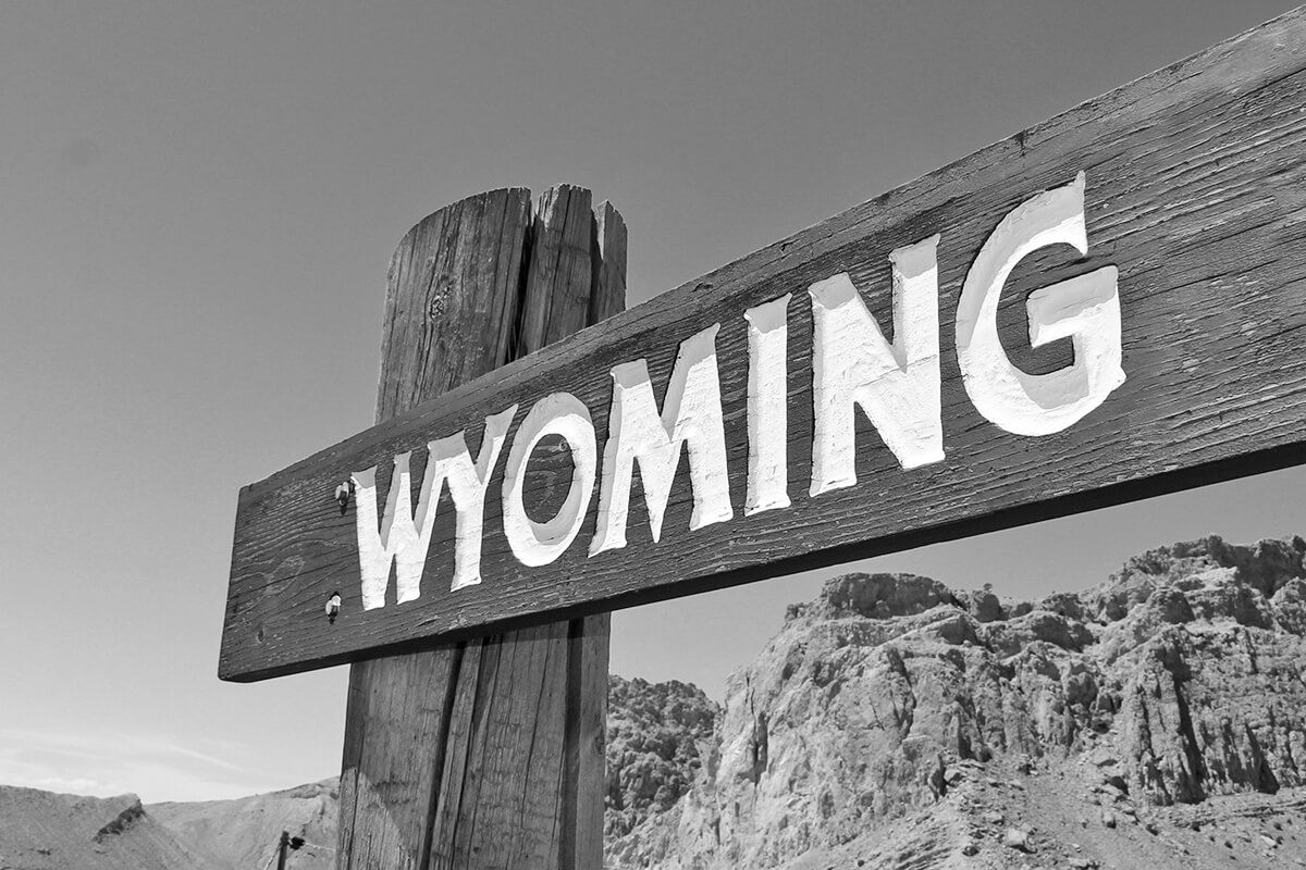 Wyoming on a wooden sign.