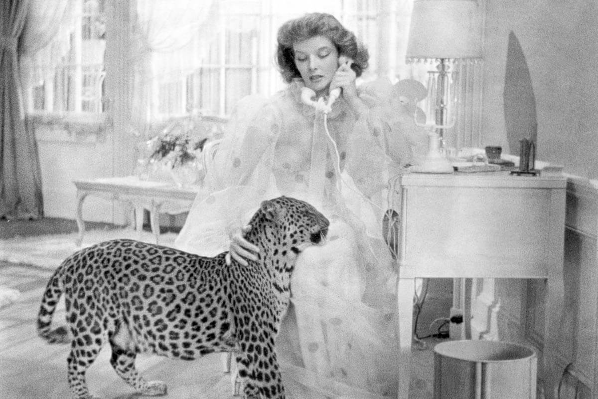 Actress Katharine Hepburn on the set of the 1938 film Bringing Up Baby with a leopard.